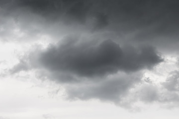 Obraz premium A gray cloud on a dark rainy dramatic sky_