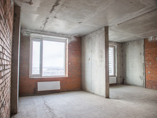 Fototapeta na wymiar Concrete and brick walls in the apartment for repair