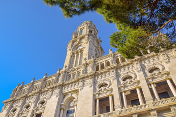Fototapeta premium Townhall Porto Portugal with blue sky and part of green tree in front