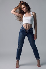 Fashion minimalist dark portrait of brunette female model on grey background. stylish clothing, black and white concept
