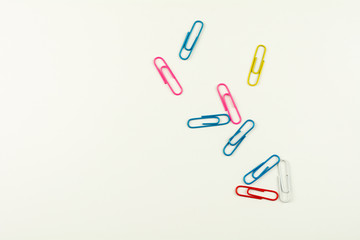 colorful paper clips on white background. - top view.
