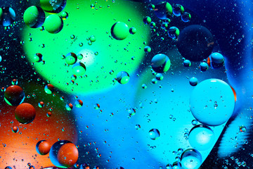 Mixing water and oil on a beautiful color abstract background gradient balls circles and ovals