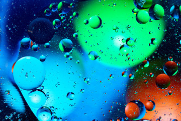Mixing water and oil on a beautiful color abstract background gradient balls circles and ovals