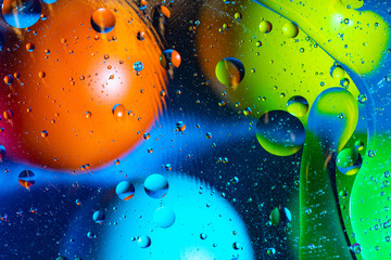 Mixing water and oil on a beautiful color abstract background gradient balls circles and ovals