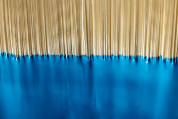 close up view of brush with blue paint