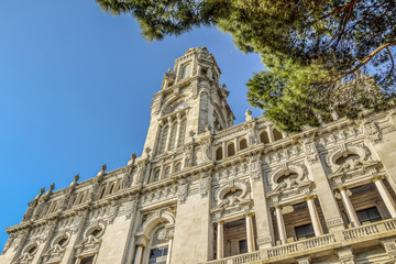 Fototapeta premium Townhall Porto Portugal with blue sky and part of green tree in front
