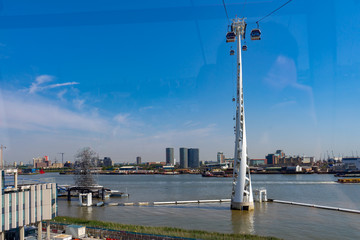 Fototapeta na wymiar Emirates Air Line cable cars on thames river in London, UK