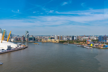 Fototapeta na wymiar Emirates Air Line cable cars on thames river in London, UK