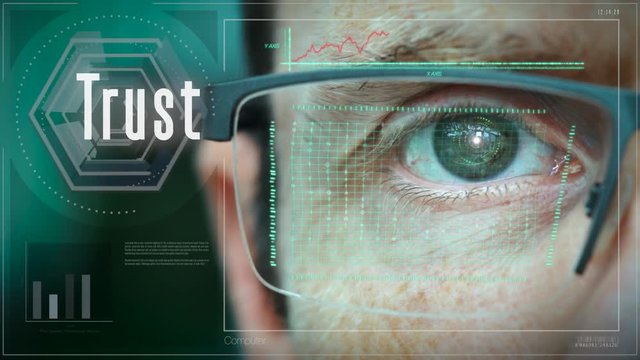 A close up of a businessman eye controlling a futuristic computer system with a Trust concept.