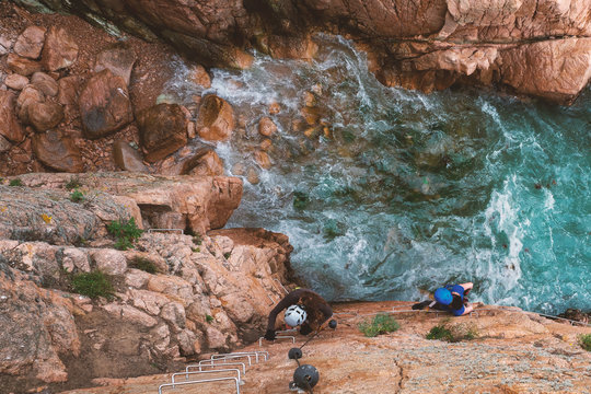 Girls climbing a via ferrata, Sant Feliu de Guixols, Catalunya, Spain (Via ferrata Cala de Mol&iacute;)
