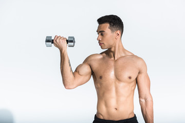 Fototapeta na wymiar handsome mixed race man with muscular torso holding dumbbells on white