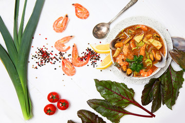 French seafood soup. Bouillabaisse ear of seafood. Food French sailors. White background, top view....