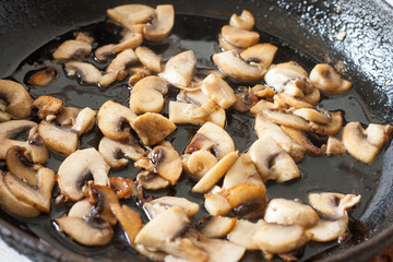 White champignons with mushrooms, fried in a pan, cooking ingredients for soup, salad. Vegetarian healthy protein food for the main course, lifestyle
