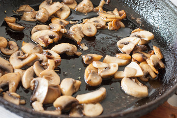 White champignons with mushrooms, fried in a pan, cooking ingredients for soup, salad. Vegetarian healthy protein food for the main course, lifestyle