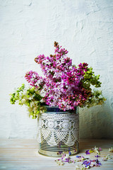 Colorful lilac flowers bouquet in vase