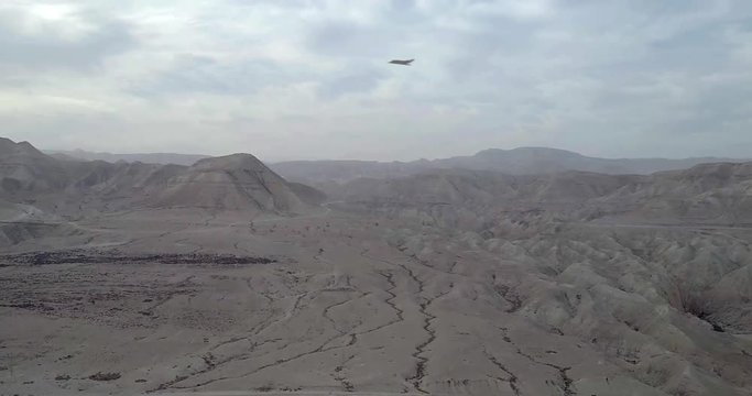 Stealth Bomber drops bombs on mountain aerial view Powerful Video Compositing simulates Real drone footage with visual effect elements of Stealth Bomber droping bombs on mountain