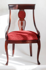 wooden chair with a red seat. on a white background. have toning
