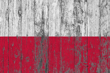 Flag of Poland painted on worn out wooden texture background.