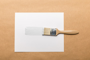 top view of brush and paper isolated on brown
