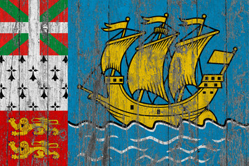 Flag of Saint Pierre And Miquelon painted on worn out wooden texture background.