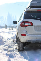 The car is white in the snow. Rubber on wheels in the snow. Snowy mountains of the Carpathians