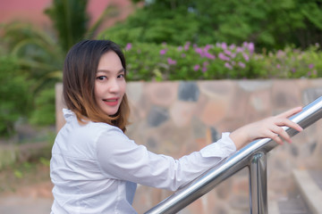 Naklejka premium Portrait of beautiful asian woman post for take a picture at outdoor,Thailand people,A pretty girl has a lifestyle for self