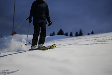 The skier rides in the snow. Splashes of snow. Snow trail in the Carpathian mountains.