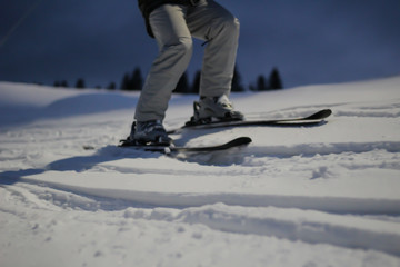 Fototapeta na wymiar The skier rides in the snow. Splashes of snow. Snow trail in the Carpathian mountains.