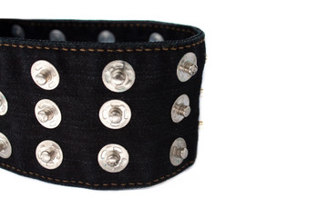 Macro picture of black jeans belt with many buttons isolated on a white background, copy space.