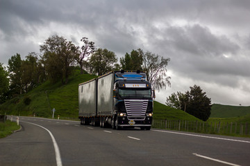 Truck driving on road in rural landscape