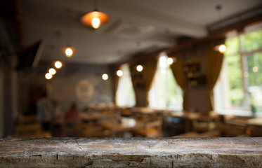 Empty wooden table in front of abstract blurred background of coffee shop . can be used for display or montage your products.Mock up for display of product
