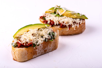 Delicious Italian antipasti bruschetta on white background. Macro.