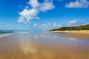 Main transportation highway on Fraser Island - wide wet sand beach coast facing Pacific ocean -...