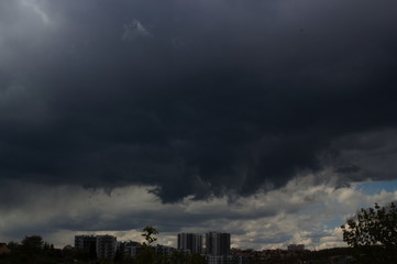 cityscape of big storm over a city in dim background. air pollution in a city