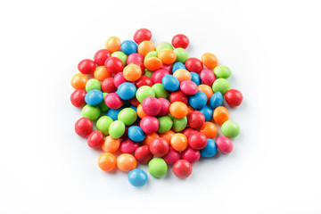 Rainbow-colored candies, multicolored close-up, texture and repetition of dragee