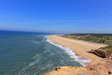 Amazing view of North Beach (Praia do Norte) coastline of Atlantic ocean. Most famous place of giant breaking waves for surfers from around the world. Nazare, Portugal