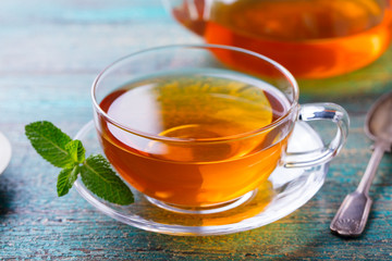Tea cup with mint leaf and lemon. Close up.