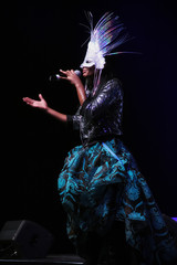 young woman in black dress and carnival mask