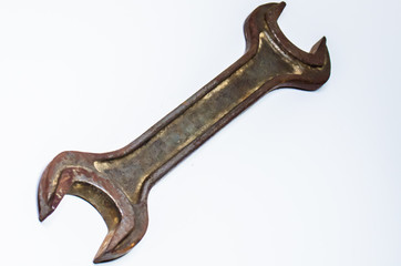 Rusty textured wrench. Isolated on white background.