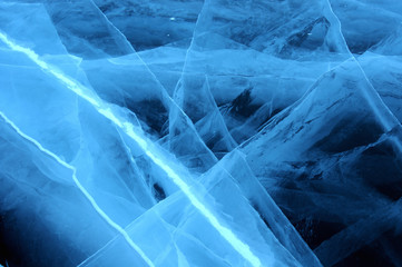 Sun rays are refracted by the transparent ice of Lake Baikal. cracks at different depths create a bizarre web
