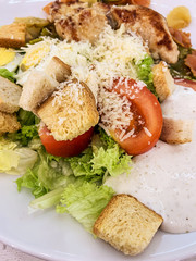 Fresh Caesar salad with chicken. Close up Caesar salad in home or dining room in healthy food concept