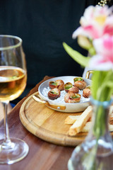 Unrecognizable woman eating escargot snails