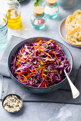 Red cabbage salad. Coleslaw in a bowl. Grey background.