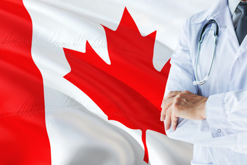Canadian Doctor standing with stethoscope on Canada flag background. National healthcare system concept, medical theme.