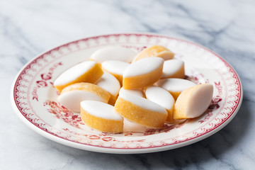 Calissons on a plate. Marble background. Traditional French Provence sweets.