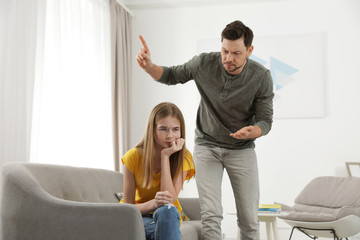 Father scolding his teenager daughter at home
