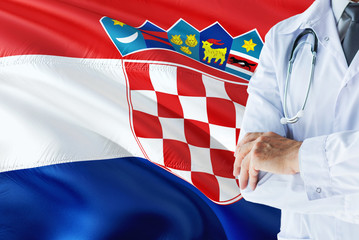 Croatian Doctor standing with stethoscope on Croatia flag background. National healthcare system concept, medical theme.