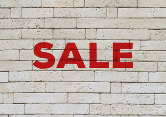 Sale marketing banner, red capital letters advertisement on a white brick wall front view, online banner ad with copy space for coupon