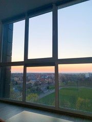 Obraz na płótnie Canvas Panoramic windows overlooking beautiful golden sunset. View from home window