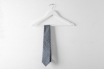 Tie on wooden hanger against white background